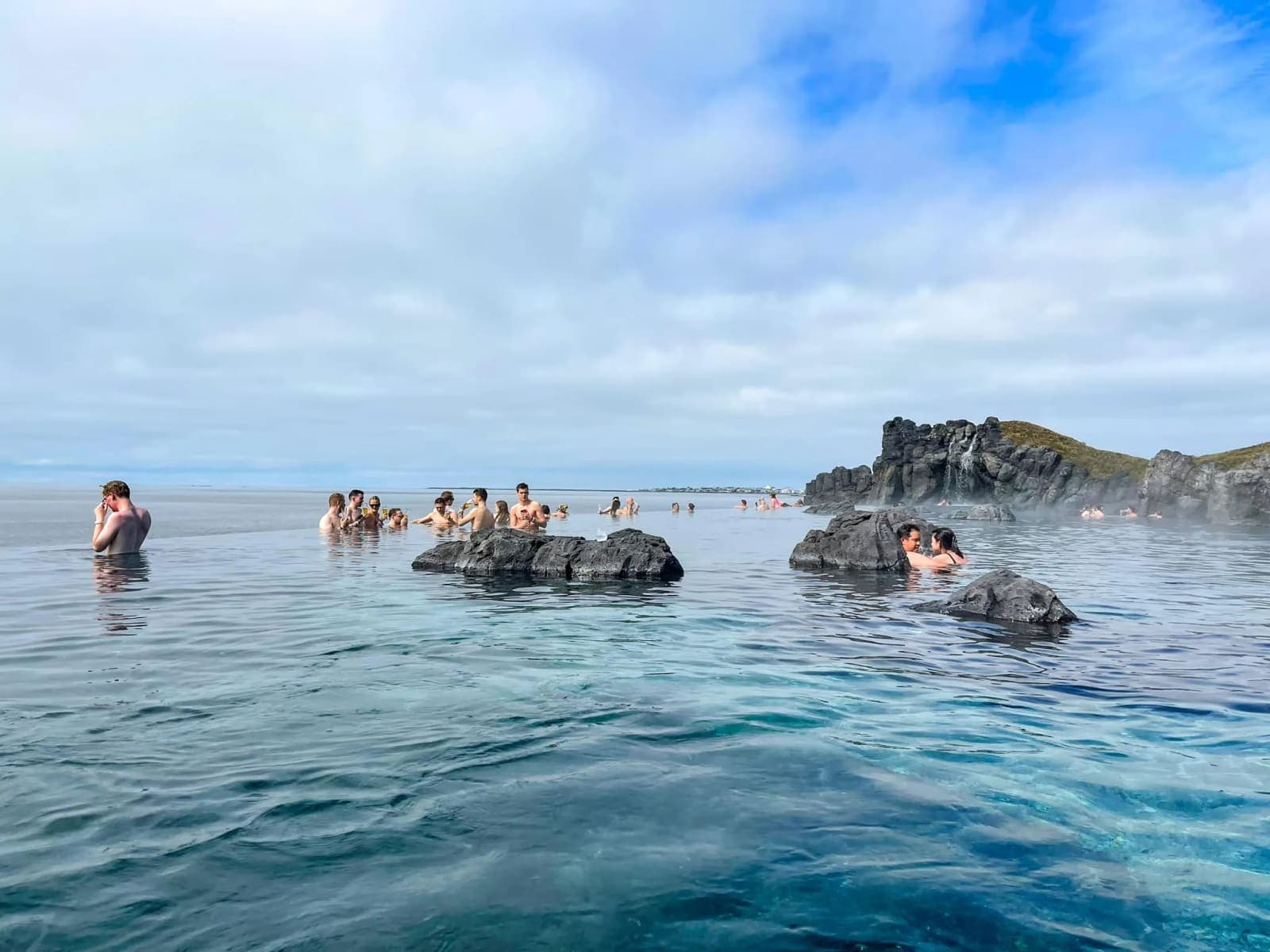 People relaxing in warm geothermal water at Sky Lagoon near Reykjavík.