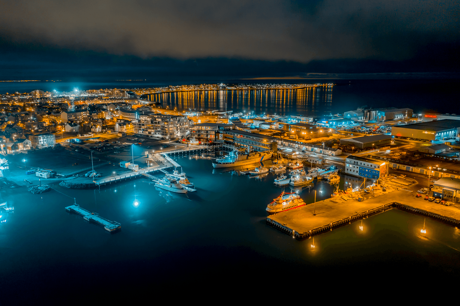 Aerial night view over Reykjavík harbour and city lights